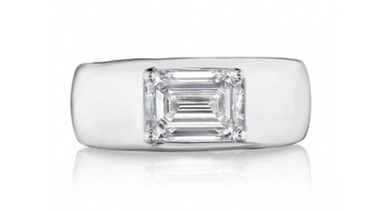 a white gold, chunky fashion ring with an emerald cut diamond