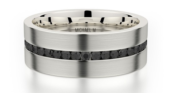 A titanium men’s wedding band by Michael M featuring an eternity strip of black diamonds, available at The Wedding Ring Shop.