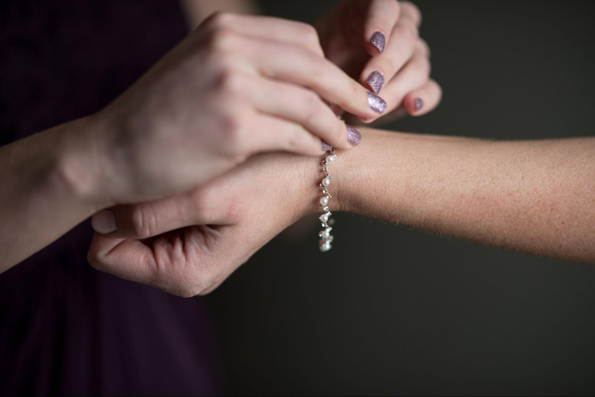 new bracelet being put on hand