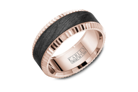 A distinctive black carbon fiber and rose gold wedding band from Carlex, available at The Wedding Ring Shop.