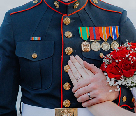 service member holding a hand